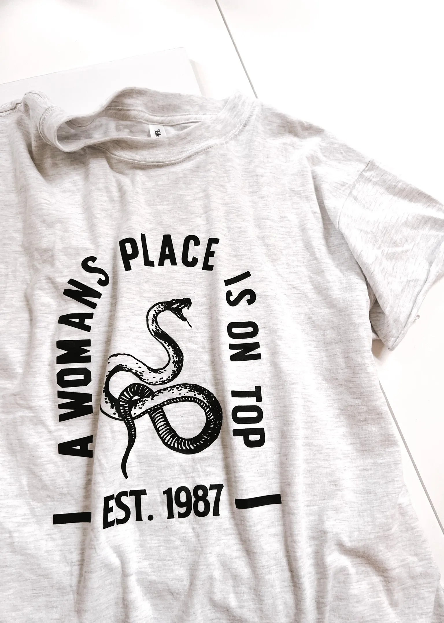 A WOMAN'S PLACE IS ON TOP SIDE SLIT TEE